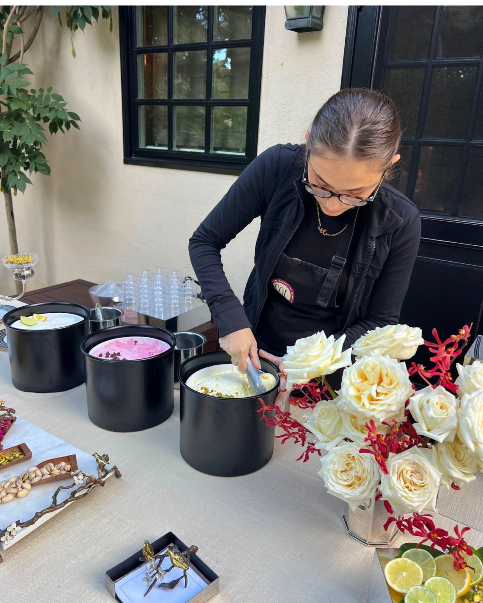 Scooping ice cream at an event table set with roses