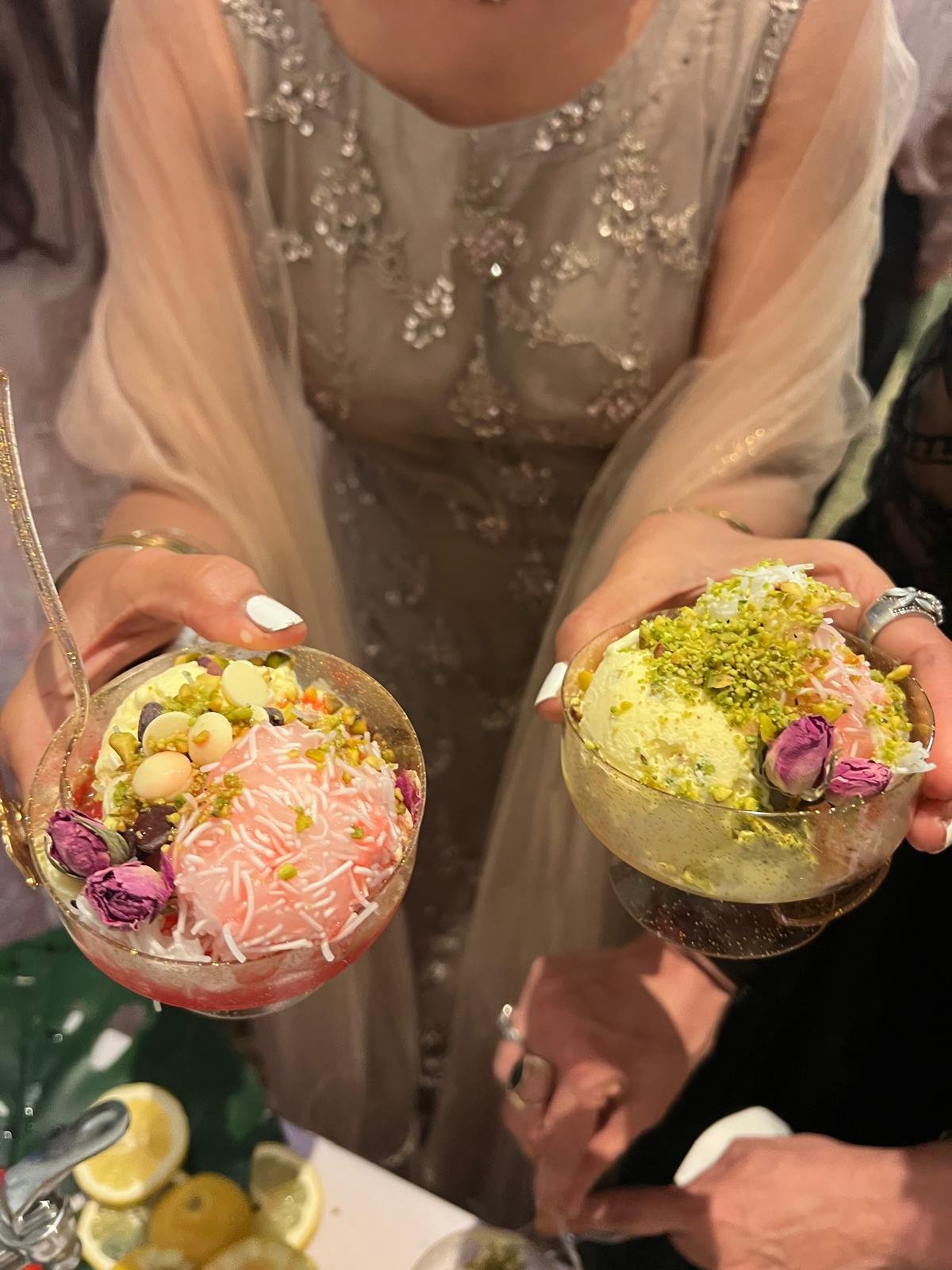 Guests holding bowls of saffron and rose ice cream