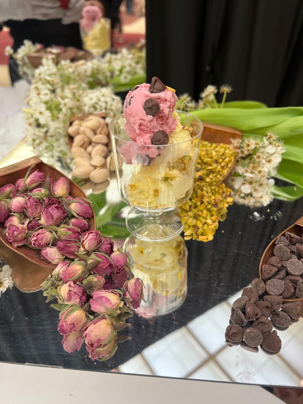 Dessert table with rose buds, pistachios and chocolate